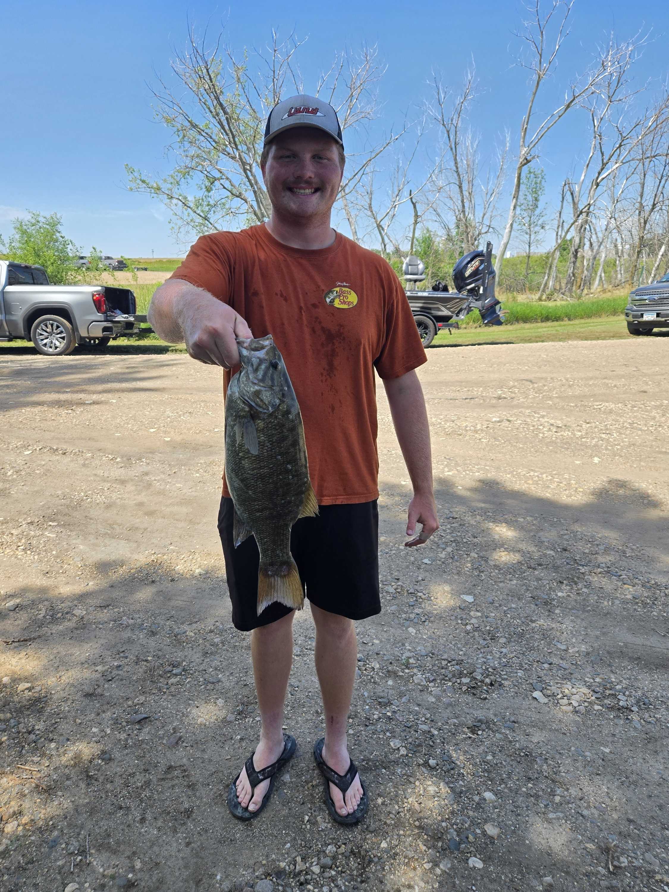 Young angler holding up a big smallmouth bass at the Blue Dog ramp